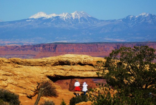 A more distant view of the arch shows off the La Salle Mountains in the Background. -- Photo by Pat Bean 