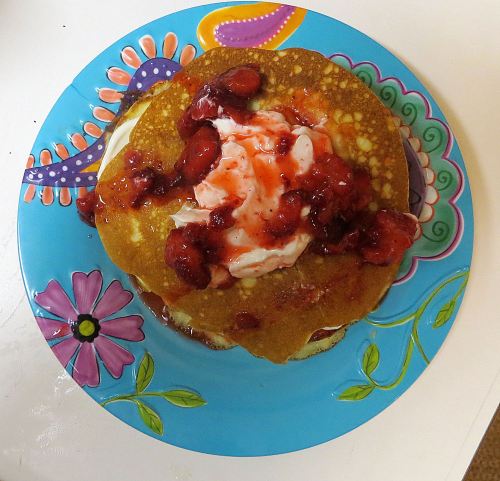 Pancakes with sour cream and strawberries for a cool morning breakfast, topped off of course with a cup of dark, cream-laced coffee. -- Photo by Pat Bean