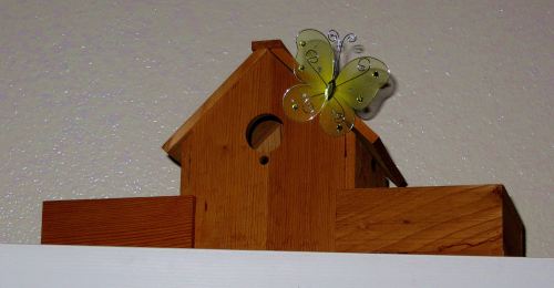 Birdhouse and butterfly atop my bookcase.  -- Photo by Pat Bean 